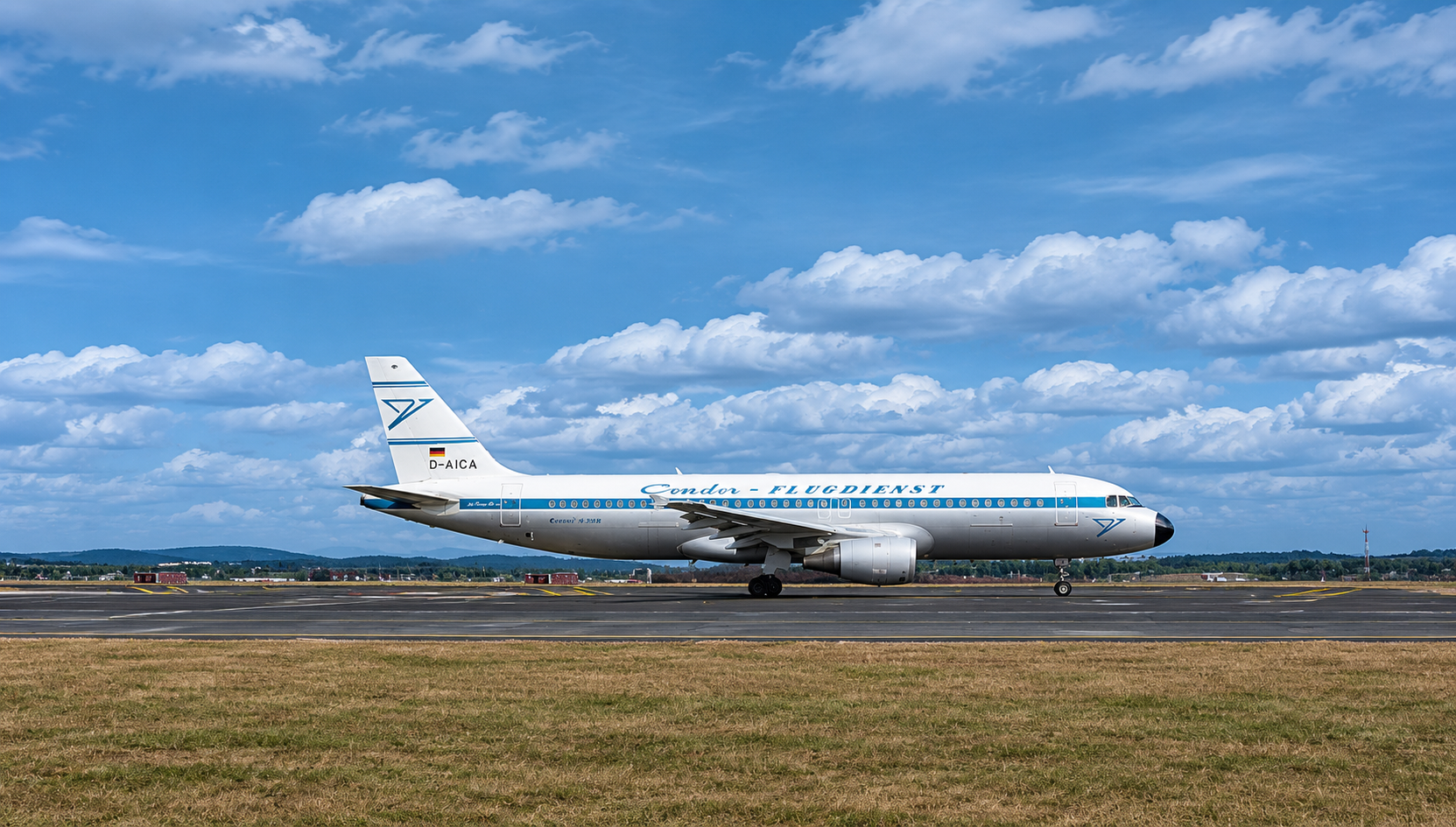 Condor aircraft in historic livery on the runway in front of a cloudy sky.